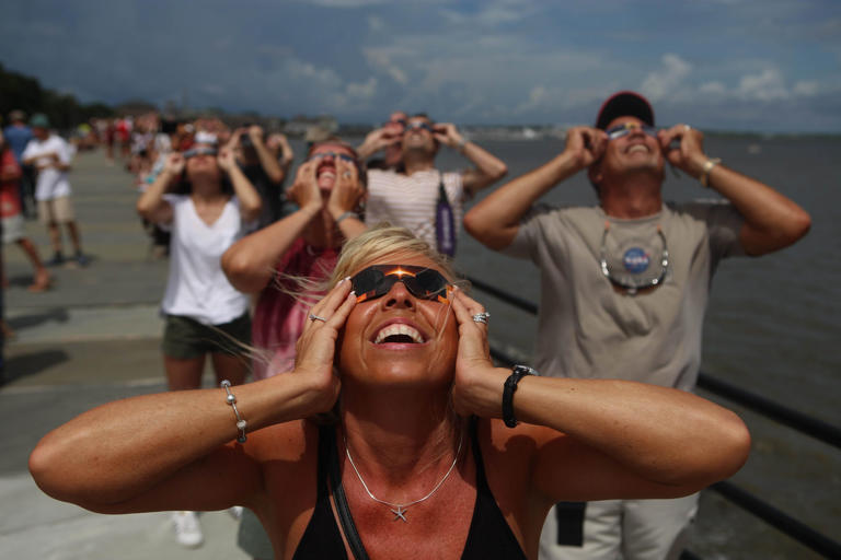 Melissa Cheatwood, from Baltimore, Maryland, gazes up as the August 2017 eclipse enters totality in Charleston, S.C.