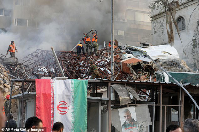 Iran has condemned Israel and vowed revenge for the strike 'at the same magnitude and harshness'. Emergency and security personnel are pictured at the strike site in Damascus today