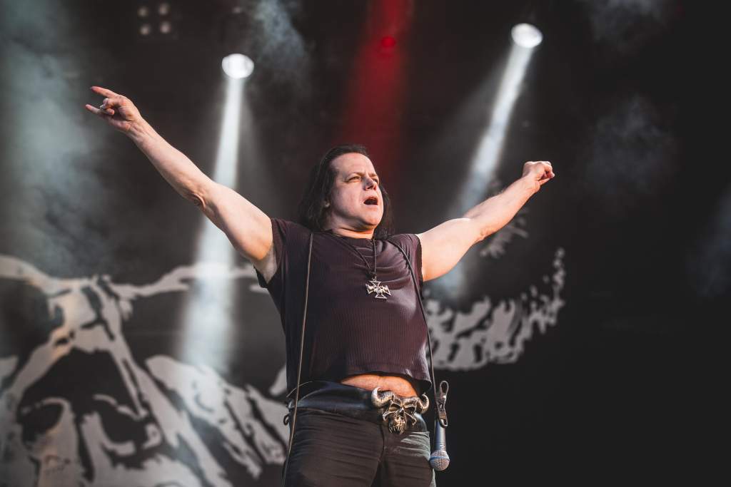 Highly influenced by Elvis Presley is singer 'Evil Elvis' Glenn Danzig. While having founded acts such as <em>Danzig and Samhain</em>, Danzig is probably best known as the original lead singer of the 1977 horror punk band <em>The Misfits</em>. The highly melodic vocals of Danzig -- combined with the horror imagery set in their lyrics -- make their music irresistibly catchy. While the themes and styles of his music starkly contrast with them, Danzig cites the 1970s Swedish pop group <em>ABBA</em> as one of his favorite musical groups. Reuniting with original line-up bandmates Jerry Only and Doyle Wolfgang von Frankenstein in 2016 after 33 long years, <em>The Misfits</em> have been touring ever since.