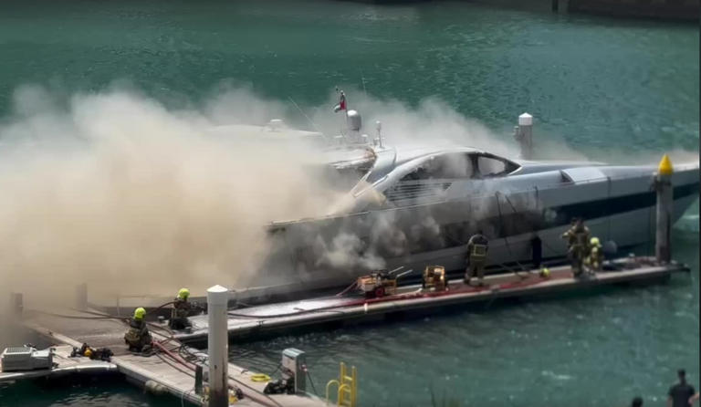 Crews tackle a blaze on a yacht in Dubai Marina. The National