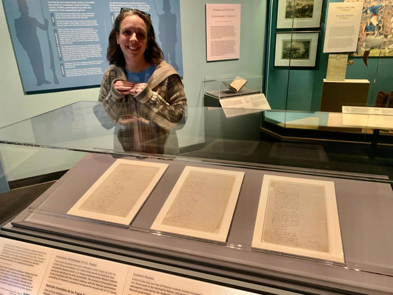 Kathryn Siefker, senior curator at the Bob Bullock Texas State History Museum, explains pages of the Treaty of Guadalupe Hidalgo on display in a special pop-up exhibit.