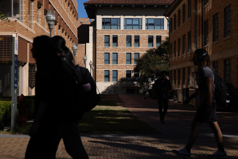 Students pass in front of the Jackson School of Geosciences and Gates-Dell Complex at the University of Texas at Austin on Feb. 22, 2024.