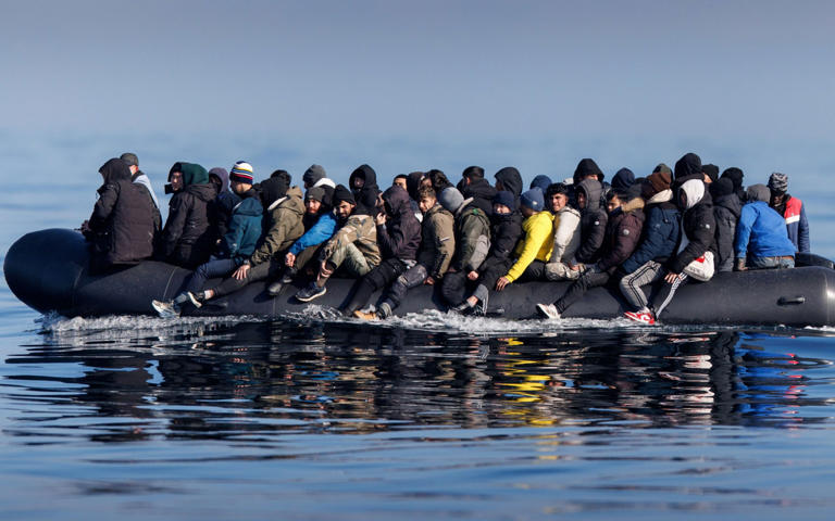 Around 60 migrants cross the English Channel on a small boat last month, with the number of crossings having surged this year - Tolga Akmen/Shutterstock