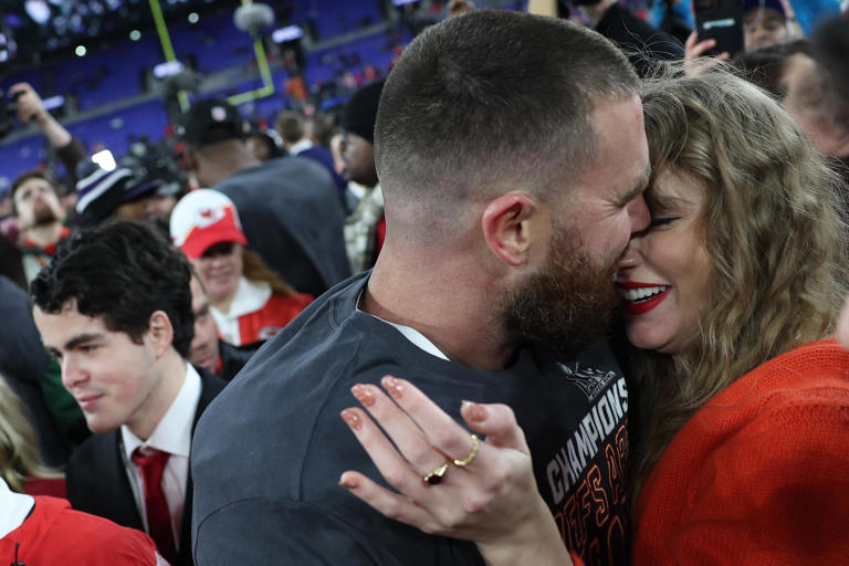 The Kansas City Chiefs' Travis Kelce embraces Taylor Swift on the field after a 17-10 victory against the Baltimore Ravens in the AFC Championship Game at M&T Bank Stadium on Jan. 28, 2024, in Baltimore.