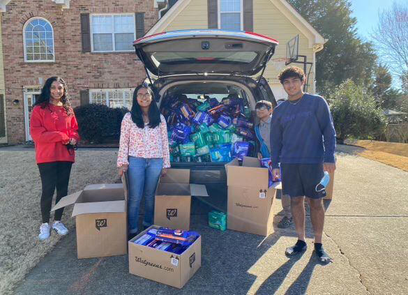 Sheona Diwakar, center, said a class assignment got her passionate about ending period poverty in her community. She started a nonprofit called Soaring Doves. Instead of a food drive, she hosted a hygiene drive. With the help of her neighbors, she gathered supplies to help 10,000 women.