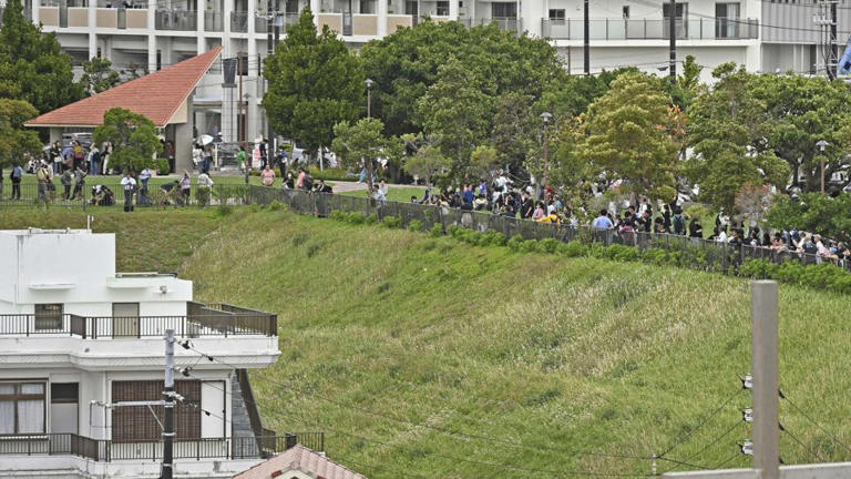 People evacuate to higher ground in Naha, Okinawa after a tsunami warning following the earthquake on Wednesday. - Kyodo News/AP