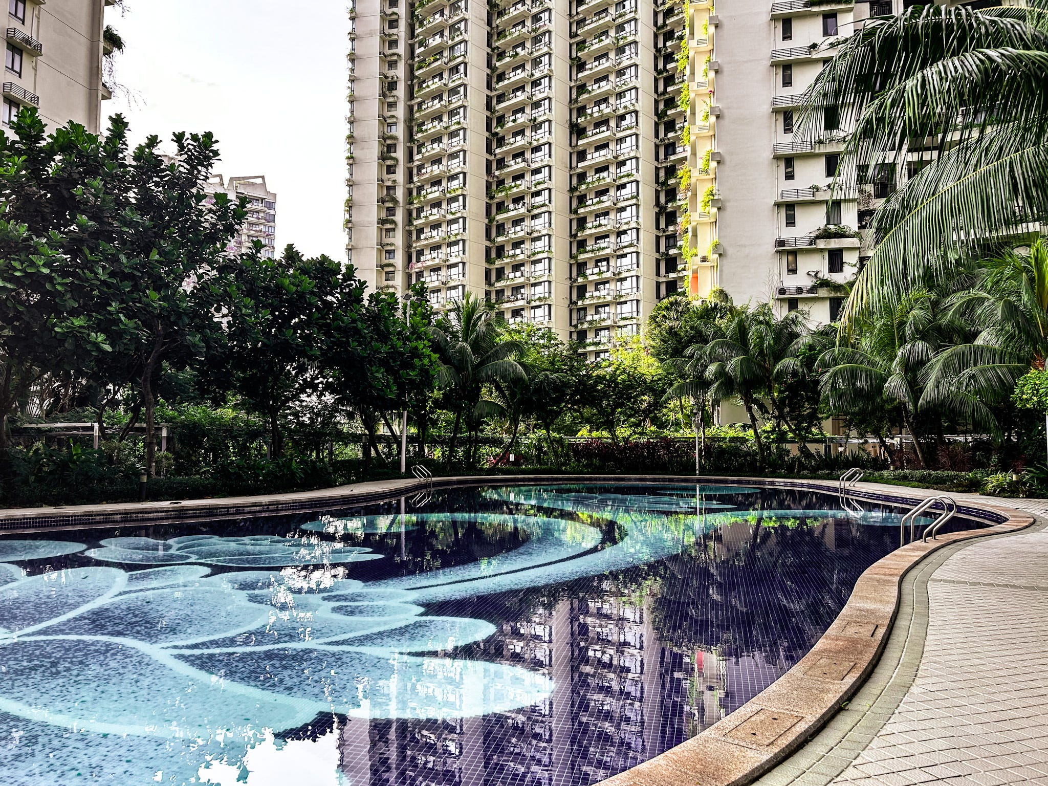 <p>Outside, there was a swimming pool, several outdoor gyms, and a playground.</p><p>There was no one at the pool in the morning. The Jacuzzi was full of cloudy-looking water.</p><p>I spotted a total of three residents, one of whom was blasting a song in Chinese from her phone and exercising on one of the tai chi spinners at the outdoor gym.</p><p>It looked like an average residential neighborhood in Singapore — with its endless<a href="https://www.businessinsider.com/see-inside-public-housing-singapore-hdb-million-dollars-blue-zone-2023-11"> blocks of public housing</a> and the ubiquitous sight of plants and trees — but without the people.</p>