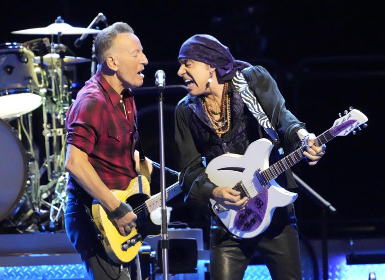 Bruce Springsteen and guitarist Steven Van Zandt share the microphone while performing with the E Street Band during Springsteen's tour relaunch at the Footprint Center in Phoenix on March 19, 2024.