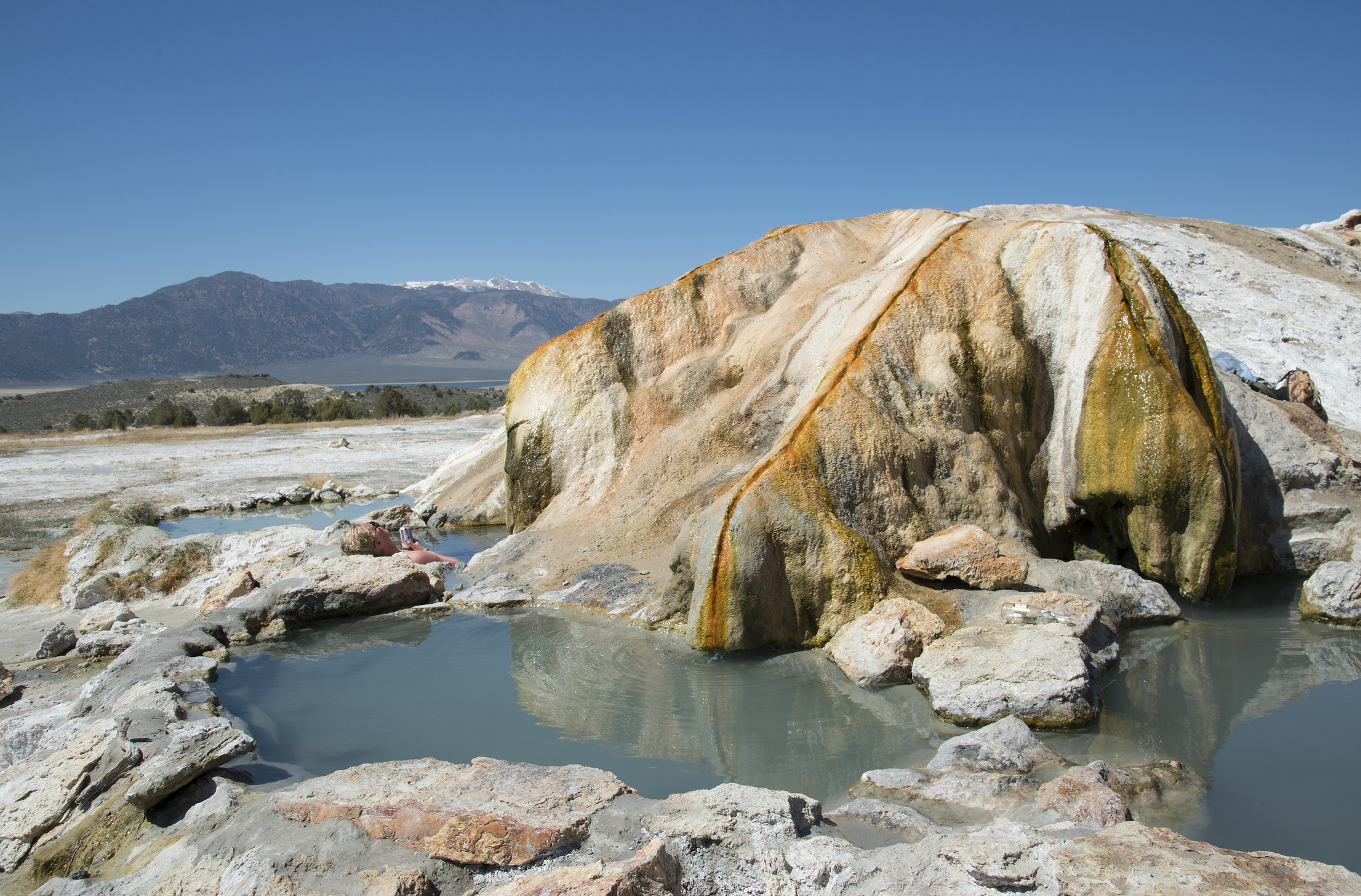 <p>The Travertine hot springs are located on public lands and are easily accessible via a short walk from the parking lot—which is free to park.</p>  <p>A Vault Restroom is available on site.</p>