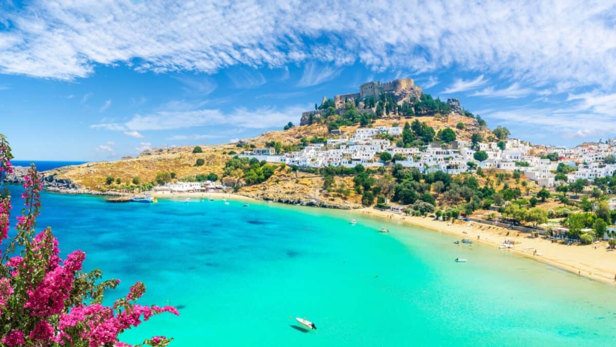 <p>This is one of my favorite Greek islands. My wife and I would spend hours wandering around its medieval streets and walled old town (one of Europe’s best-preserved medieval towns). There are so many little shops and cafes in the old town where you can relax and enjoy the fantastic weather.</p><p>When you are done with the city, you can head to the beach! My favorite beach was Elli Beach, located just outside the old town. It has a diving board you can swim to and jump off, which was one highlight of my trip to Greece.</p>