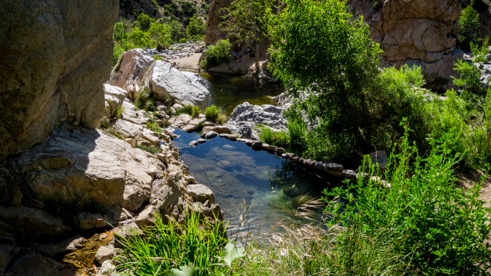 <p>There are two routes available to the hot springs, both are somewhat challenging with one route being a 2 mile hike up a steep mountain, and the other being a mostly even 6-mile hike.</p>  <p>Parking is available close by for a fee. Camping and campfires are not permitted.</p>