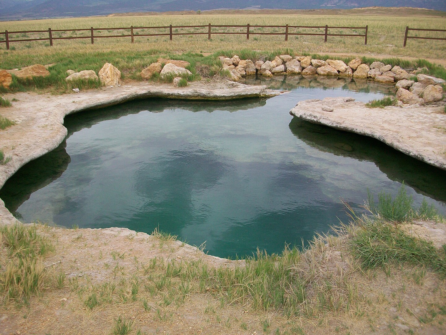 <p>Located just 4 miles south of Fillmore, in Meadow, Utah.</p>  <p>This natural hot spring is only one large pool but it is very warm, and <strong>very deep</strong>—allowing for diving and exploring.</p>
