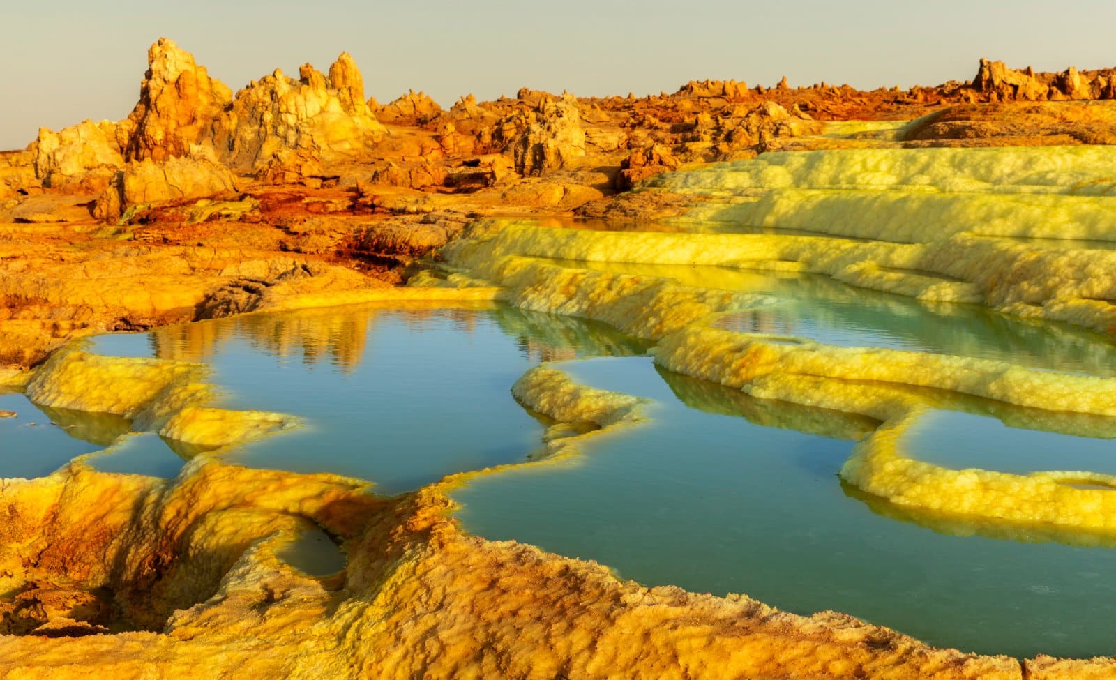<p><span>One of the most alien landscapes on Earth, the Danakil Depression offers a vista of lava lakes, salt flats, and sulfur springs. This harsh but mesmerizing environment is not for the faint-hearted but rewards the adventurous with its otherworldly beauty. </span></p> <p><b>Insider’s Tip: </b><span>A guided tour is essential for navigating the extreme conditions and understanding the geological and cultural significance of the area. </span></p> <p><b>How to Get There: </b><span>Organized tours typically depart from Mekele, accessible by flight or bus from Addis Ababa.</span></p> <p><b>When to Travel: </b><span>Visit from November to February when temperatures are slightly cooler.</span></p>