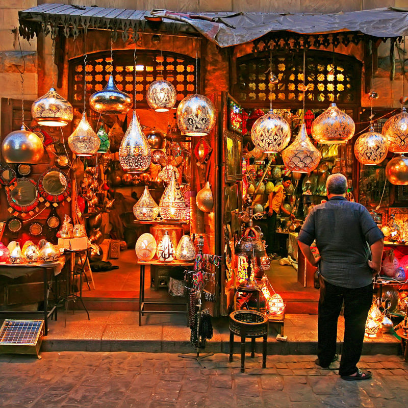 Shop and man in front of the shop at dusk in the Souk Khan el-Khalili (bazaar or market), Cairo, Egypt