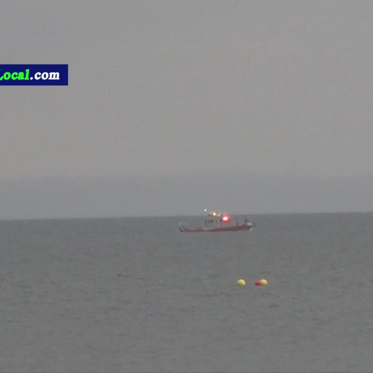 A boat searches the waters in the Long Island Sound.