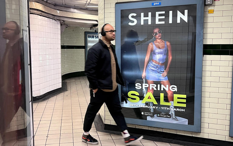 A person walks past an advertisement for Shein, in London, Britain