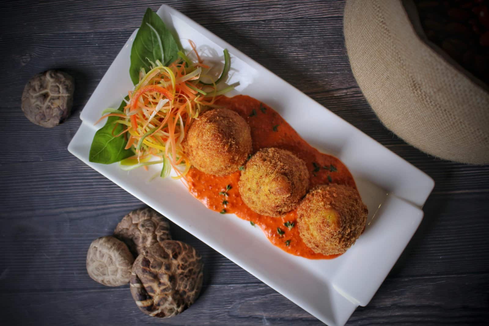 Image Credit: Pexels / Shameel mukkath <p><span>Satisfy your afternoon cravings with arancini, a Sicilian specialty that’s both delicious and satisfying. These golden orbs of goodness are made from seasoned rice, stuffed with a savory filling such as ragù (meat sauce), mozzarella, and peas, then coated in breadcrumbs and fried to perfection. Sample them in Palermo, where arancini are a beloved street food favorite, enjoyed by locals and visitors alike. Let each bite of these crispy, flavorful treats transport you to the sunny shores of Sicily, where the culinary traditions are as rich and vibrant as the island itself.</span></p>