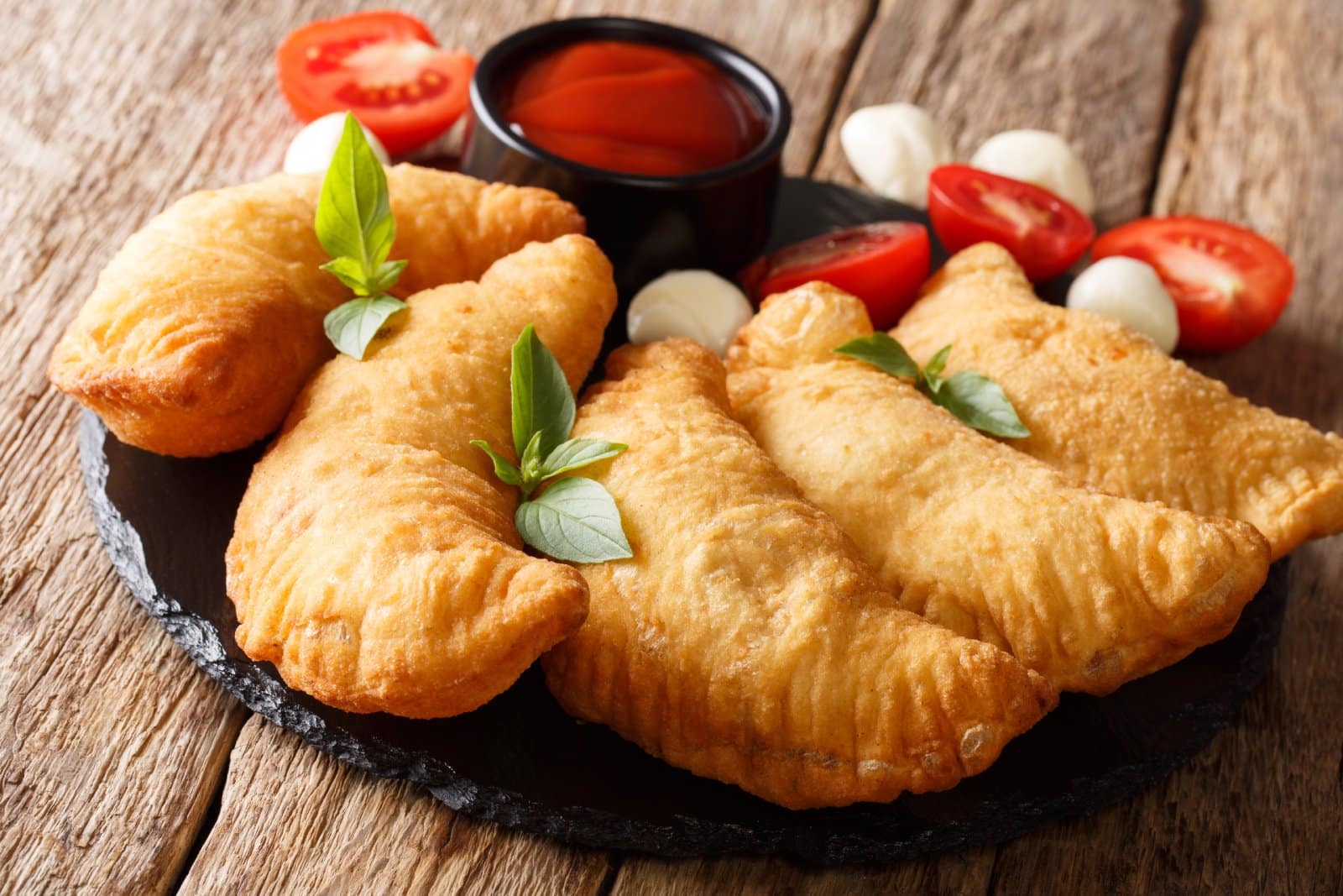 Image Credit: Shutterstock / AS Foodstudio <p><span>Treat yourself to panzerotti, a beloved street food from Bari, Puglia, reminiscent of a miniature calzone. These deep-fried pockets of dough are filled with a savory mixture of tomato, mozzarella, and your choice of fillings, ranging from spicy sausage to tender eggplant. Grab a few from a local bakery or street vendor and savor their crispy exterior and gooey center as you explore the historic streets of Bari.</span></p>