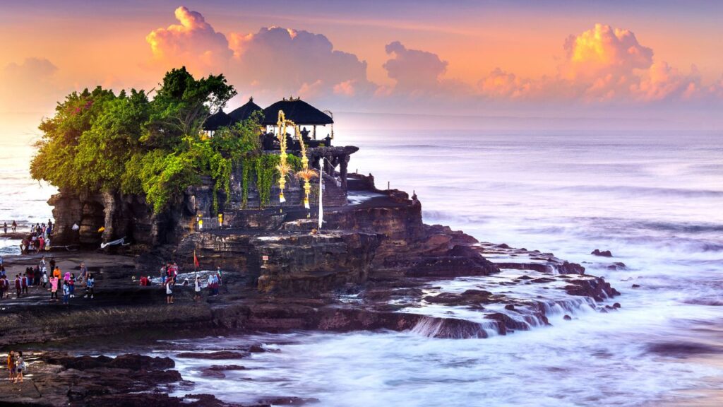 <p><span>Tanah Lot, near Canggu, is one of the best places in Bali to watch a sunset. The small temple sits on a rocky outcrop jutting out into the ocean, offering an uninterrupted view of the western horizon. Locals can only access the temple itself, but you can walk around the </span><span>grounds or watch the sunset from the adjacent sandy beach. </span></p>