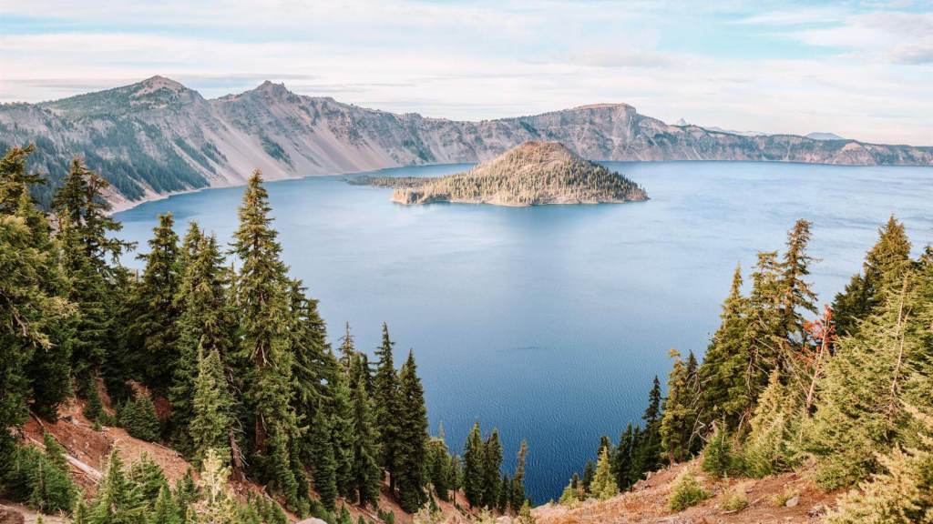 <p>Although Oregon has many incredible places to visit, it only has one national park, Crater Lake National Park. Visiting it is, therefore, one of the best ways to explore Oregon’s nature. That aside, the scenery in this park is staggeringly beautiful. </p><p>From the views of the deepest and one of the most pristine lakes in the US, Crater Lake, to Mount Thielsen, Klamath Falls, the deserts lands of Eastern Oregon, and green rolling hills that lead to the Pacific, this park offers fantastic scenery to indulge in.</p><p>Additionally, Crater Lake National Park offers fantastic sunset and sunrise views. Stay around at dawn and dusk to catch the beautiful interplay of the sun’s rays on the skies and the reflections on the lake’s waters. </p><p class="has-text-align-center has-medium-font-size">Read also: <a href="https://worldwildschooling.com/us-lake-destinations/">Charming Lake Destinations in the US</a></p>