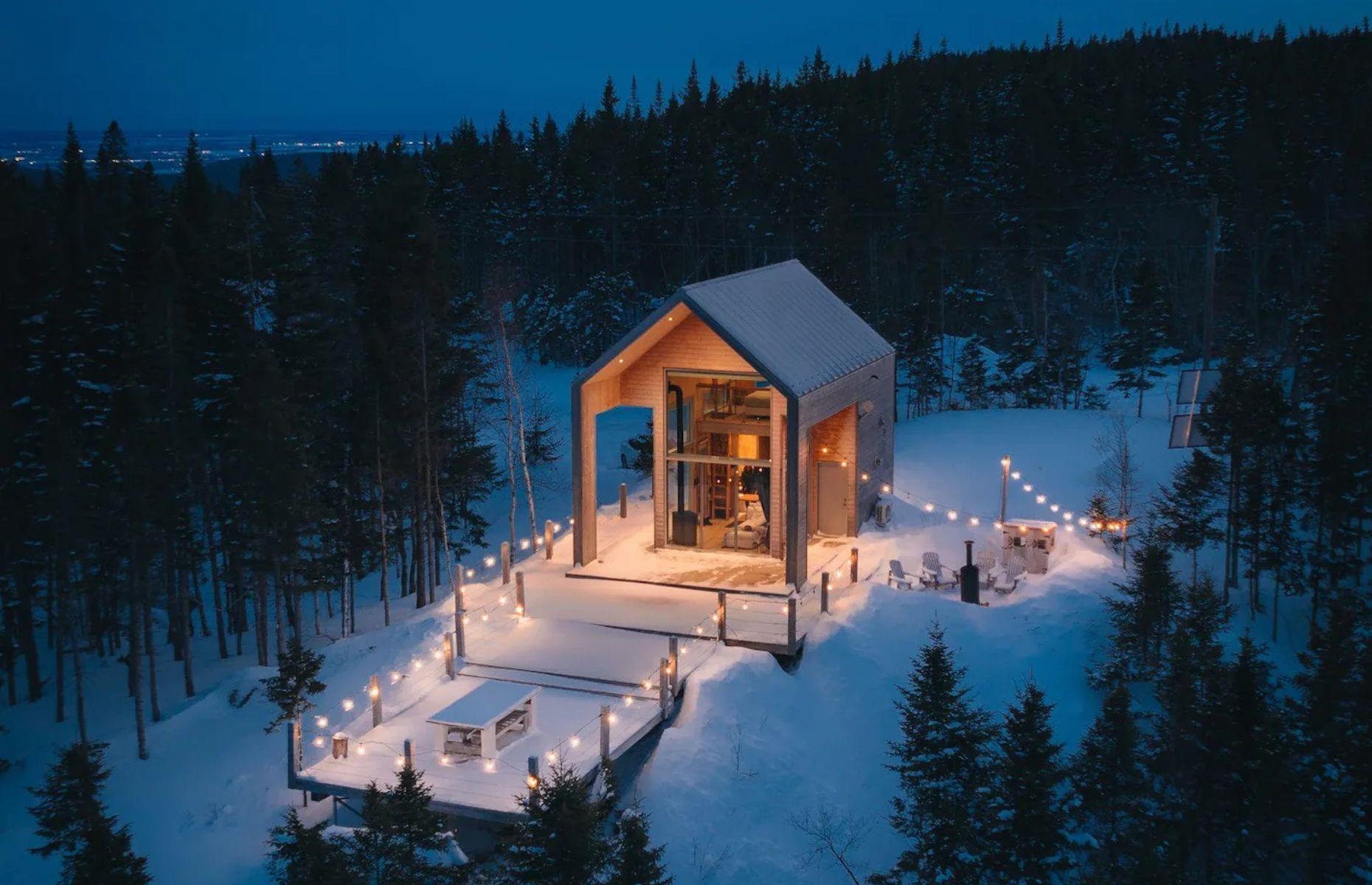 <p>Known as <a href="https://www.airbnb.ca/rooms/27050494?">Le Lagöm</a>, a Swedish word meaning "just the right amount," this envy-inducing retreat can be found on a stunning elevated plot overlooking the mountains of Lac-Beauport and the Saint Laurent River. Secluded among towering trees, the timber tiny home has been described as an ecologic chalet and runs entirely off solar power, making it as sustainable as it is attractive.</p>