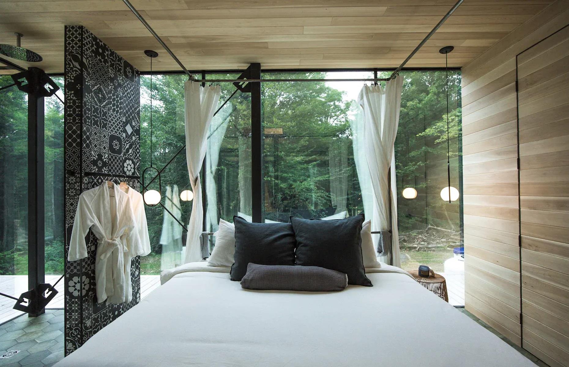 <p>With an open layout, the master bathroom has all-glass walls that allow for dreamy woodland views, while fluffy robes add to the romance. There's also a sunken bathtub, positioned next to the window, so you can become one with nature while you soak.</p>  <p>What's more, the stilted chalet is bike in/bike out and is only a few minutes' drive from the region's ski slopes, making it the ultimate getaway spot for all seasons.</p>