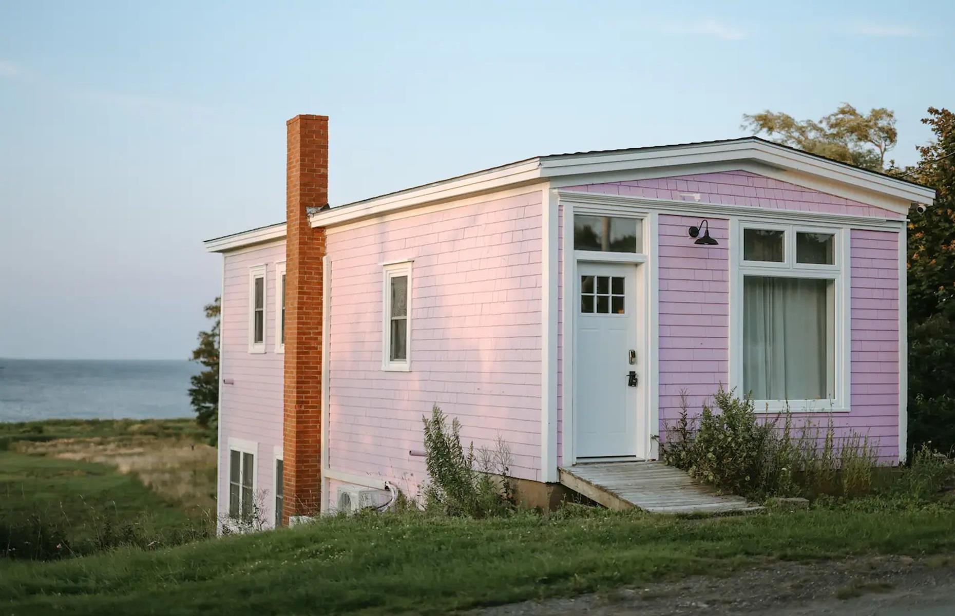 <p>Pretty in pink, this property is as adorable as it is inviting. Known as <a href="https://www.airbnb.ca/rooms/602738350100720466?adults=1&children=0&enable_m3_private_room=true&infants=0&pets=0&check_in=2024-02-04&check_out=2024-02-09&source_impression_id=p3_1706191845_qXio7JmgJWEtRvfP&previous_page_section_name=1000&federated_search_id=00a55313-1bbe-441a-a50e-ac4f5e0e5556">South Shore Cottage</a>, it might not look like much from the outside, but it's located in one of Canada's most enchanting places: Rose Bay, Nova Scotia. Moments from the beach, the teeny cottage is secluded but handily just 20 minutes from Lunenburg – one of Canada's prettiest locales. Let's head inside...</p>