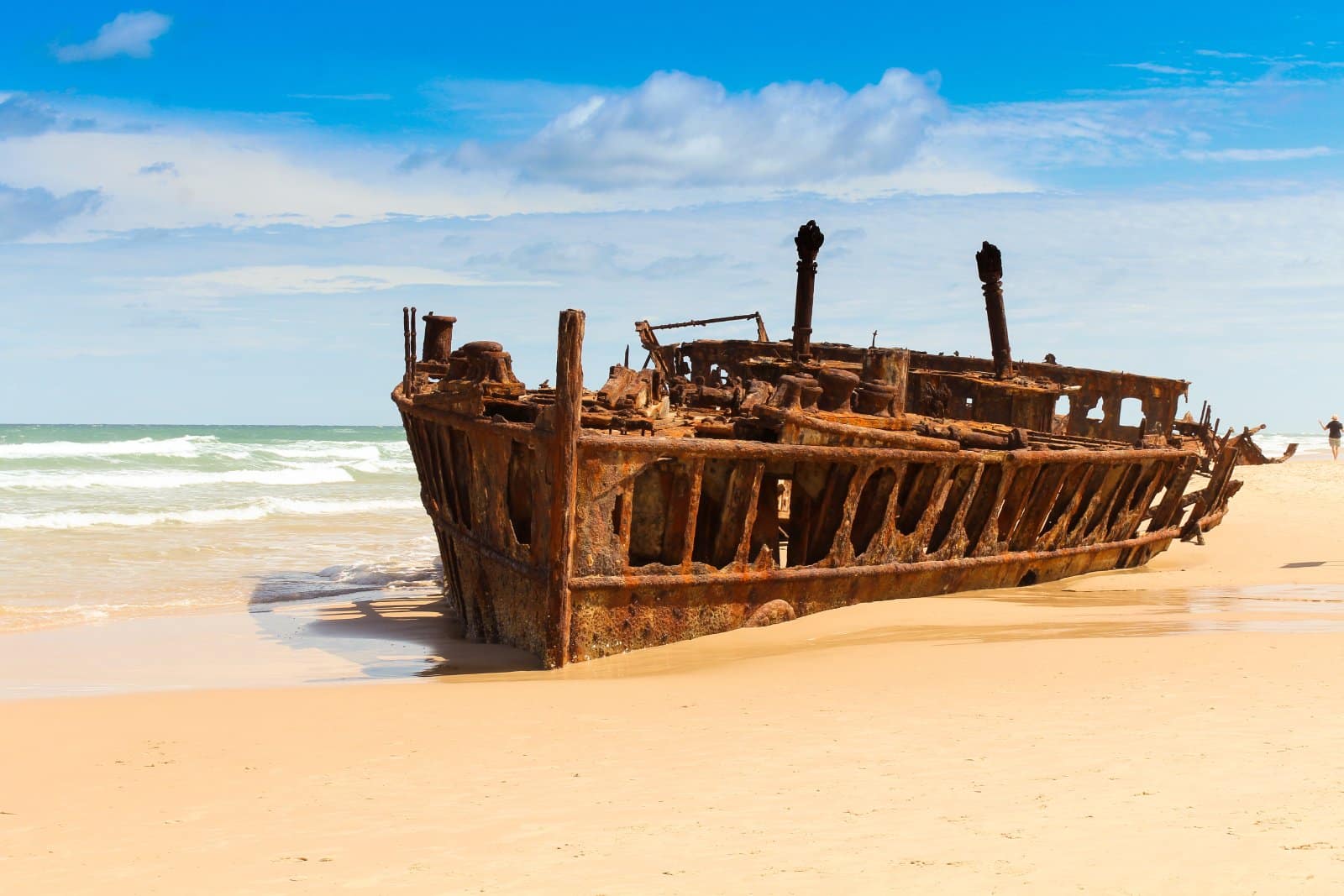 <p class="wp-caption-text">Image Credit: Shutterstock / Yannik Photography</p>  <p><span>The SS Maheno, a former ocean liner, and World War I hospital ship, met its fate on the shores of Fraser Island in 1935, stranded by a cyclone while being towed to a Japanese scrapyard. Today, its rusting hulk is a haunting yet fascinating landmark on the island’s eastern beach.</span></p> <p><span>The contrast of the corroded steel against the pristine sands and turquoise waters of the Coral Sea creates a striking scene, drawing visitors from around the globe. The ship’s history and dramatic end make the SS Maheno a must-see for anyone visiting Fraser Island.</span></p> <p><b>Insider’s Tip:</b><span> Visit at low tide when more of the wreck is exposed, offering a better view and photographic opportunities. Early morning or late afternoon light casts dramatic shadows, enhancing the wreck’s eerie beauty.</span></p> <p><b>When to Travel:</b><span> The best time to visit Fraser Island is from June to October, avoiding the peak of the Australian summer while enjoying mild weather.</span></p> <p><b>How to Get There:</b><span> Fly into Hervey Bay or Sunshine Coast airports, then take a ferry or a barge to Fraser Island. The SS Maheno is accessible by 4WD along Seventy-Five Mile Beach.</span></p>