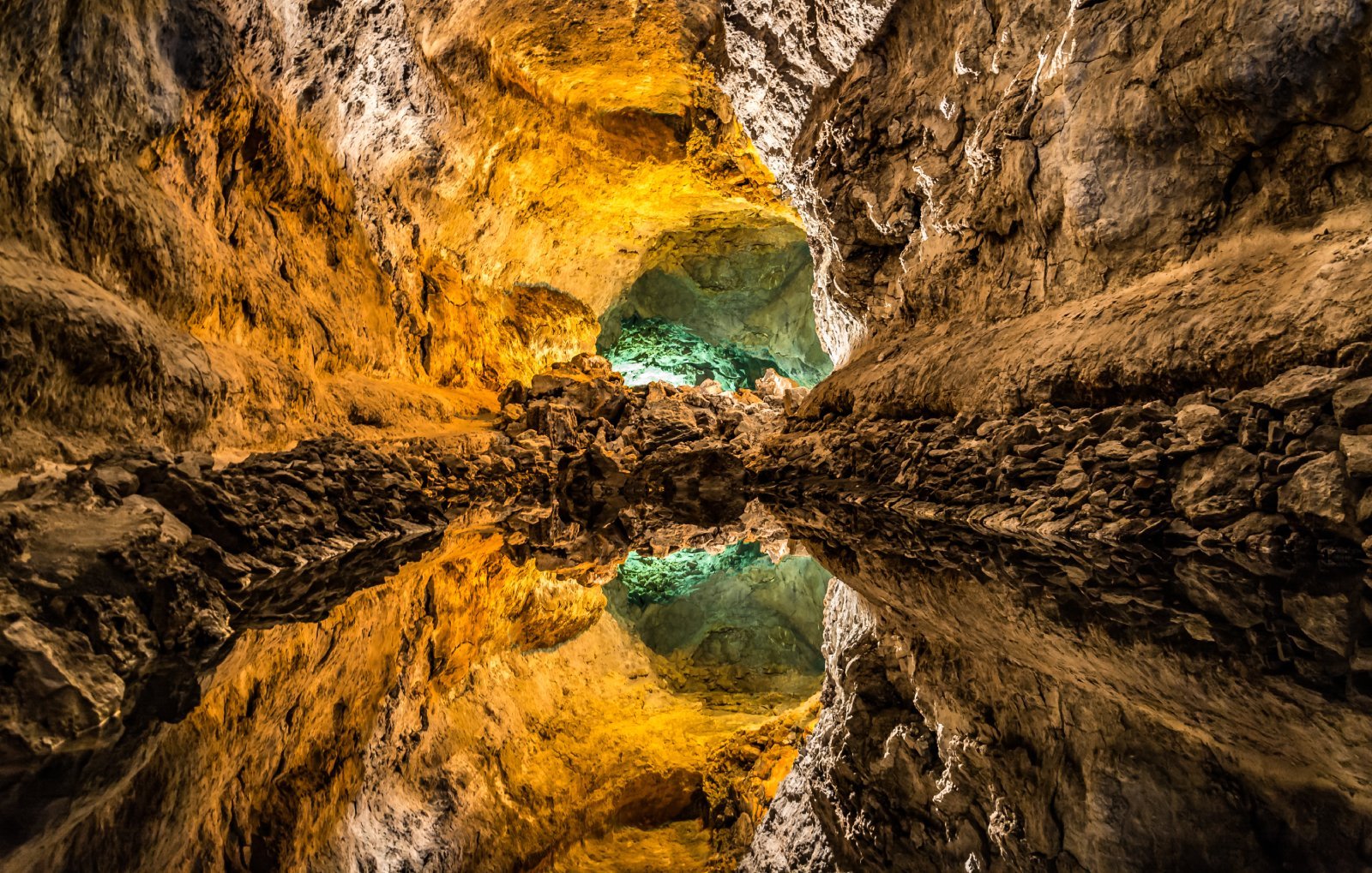 <p class="wp-caption-text">Image Credit: Shutterstock / Tomasz Czajkowski</p>  <p><span>Cueva de los Verdes, part of a monumental lava tube system in the northern part of Lanzarote, Canary Islands, Spain, offers a unique exploration experience distinct from the deep, vertical cave systems often associated with speleology. Formed around 3,000 years ago by volcanic flows from Monte Corona, the cave extends over 6 kilometers above sea level and includes an additional 1.5 kilometers below the sea.</span></p> <p><span>Unlike traditional caves formed by water erosion, Cueva de los Verdes was sculpted by molten lava, creating a network of tunnels and caverns with smooth walls and peculiar shapes. This cave is renowned for its geological significance and cultural impact, having served as a hideout from pirates and invaders in historical times.</span></p> <p><span>Today, it is part of a managed visitor attraction, with guided tours taking visitors through illuminated paths highlighting the cave’s natural beauty and acoustic properties. The cave also hosts a unique concert hall, showcasing its exceptional sound qualities.</span></p> <p><b>Insider’s Tip: </b><span>While the cave is accessible to the general public, joining a guided tour is mandatory. These tours offer valuable insights into the cave’s geological formation, history, and ecological significance. Wear comfortable walking shoes and bring a light jacket, as temperatures inside the cave can be cooler than the surface.</span></p> <p><b>When to Travel: </b><span>Cueva de los Verdes can be visited year-round, thanks to Lanzarote’s mild climate. However, visiting during the off-peak season (spring and autumn) can offer a more tranquil experience, avoiding the larger crowds of summer.</span></p> <p><b>How to Get There: </b><span>Lanzarote is well-connected by air with flights from mainland Spain and other European cities. Once on the island, Cueva de los Verdes is easily accessible by car or bus from Arrecife, the island’s capital. The cave is located near the town of Haría in the north, with clear signage directing visitors to the site.</span></p>