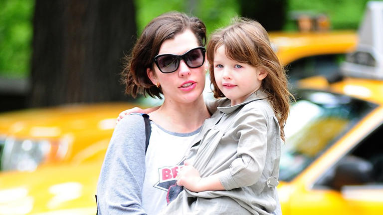 Milla Jovovich carrying Ever Anderson