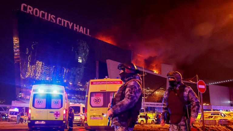 Law enforcement officers outside the burning Crocus City Hall concert venue following the attack on Friday. - Yulia Morozova/Reuters