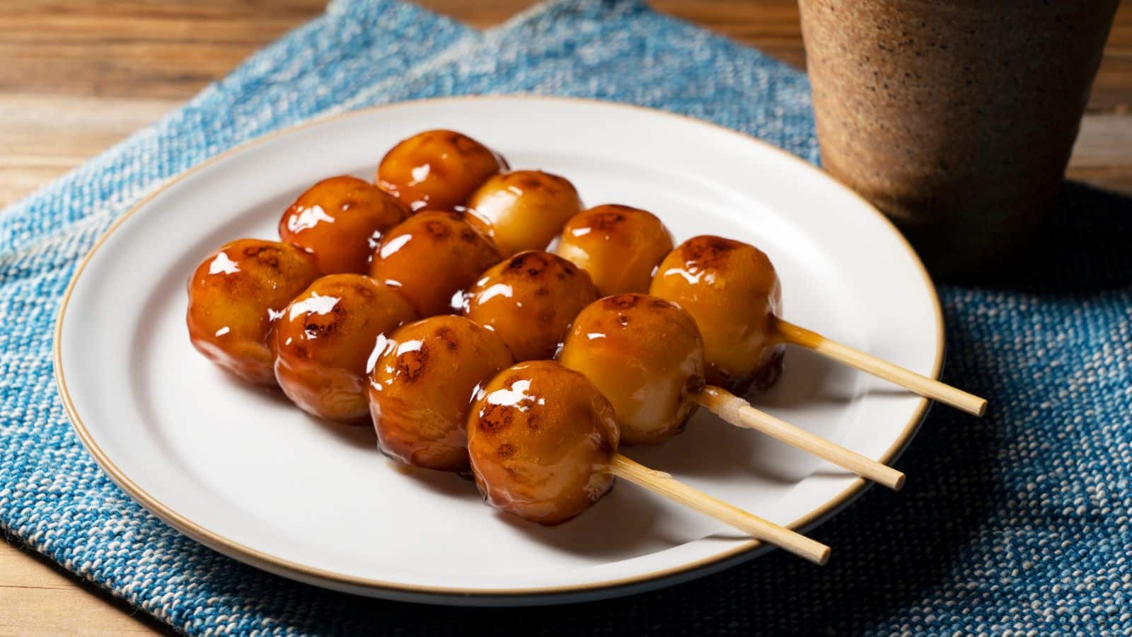 <p><span>Dango is a traditional Japanese dessert made of small round balls of mochi (rice flour) skewered on a stick. It comes in various flavors, such as green tea, red bean, and sesame, and is a popular snack to enjoy while strolling through the streets of Japan.</span></p><p><span>Dango isn’t merely a street snack; it’s a taste of Japanese tradition. With each bite, you experience the delicate sweetness and soft texture that is so characteristic of mochi, taking you on a sensory journey through the Land of the Rising Sun. I’m not drooling; you are.</span></p>