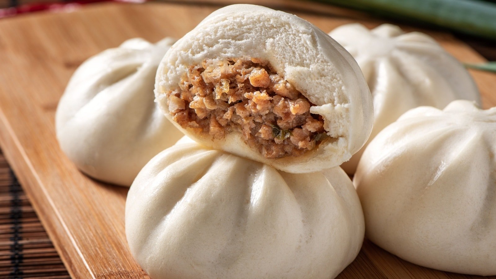 <p><span>Bao buns (also known as baozi) are steamed buns filled with various savory fillings such as pork, chicken, or vegetables. These fluffy and flavorful bites are a popular street food in China and can be found on almost every corner.</span></p><p><span>Bao buns are more than just a quick bite; each soft, warm bun is like a fluffy pillow of heaven, with a surprise inside that leaves you wanting more. The magic lies in the balance of the soft, slightly sweet bun and the savory filling; it’s a harmony of flavors that truly represents the heart and soul of Chinese street food culture. When you get a chance to try a bao bun, don’t just take a bite; take a moment to appreciate the tradition and craft that goes into each bun.</span></p>