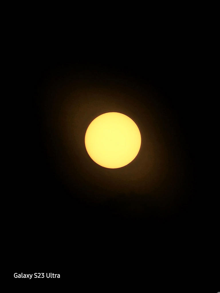 But using a solar filter reduces the amount of light entering the camera, so you can actually seen the shape of the sun. (Chris Velazco/The Washington Post)