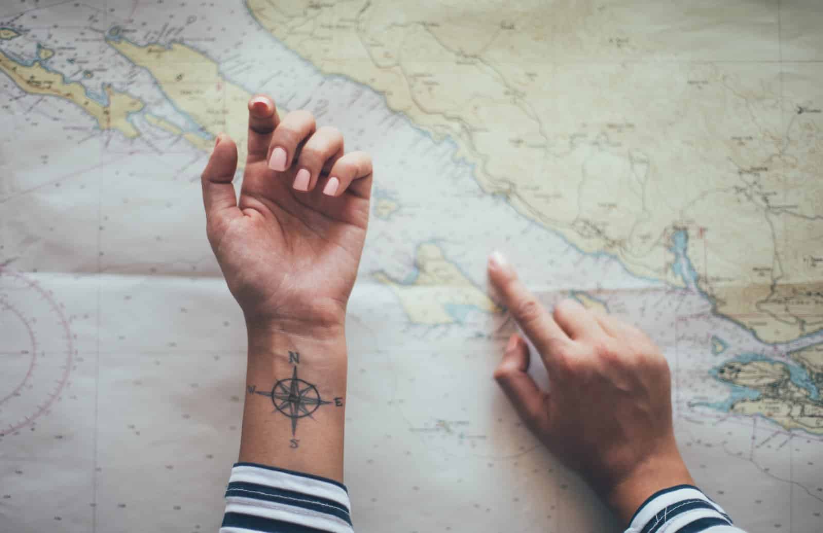 <p class="wp-caption-text">Image Credit: Shutterstock / Popartic</p>  <p><span>The compass rose has long stood as a navigation symbol, guiding travelers across uncharted territories. When tattooed, this timeless emblem signifies a wanderer’s quest for exploration and the constant journey through life’s metaphorical compass points. It’s a reminder that you possess the innate ability to find your way no matter where you are.</span></p> <p><b>Insider’s Tip:</b><span> Opt for a design that integrates personal elements or destinations that hold special meaning to you. Customizing the compass points to represent significant locations can add a layer of personal significance to your tattoo.</span></p>