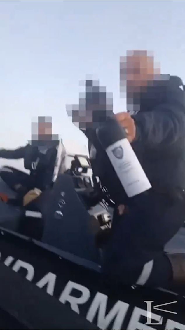 moment french police boat closely circles migrant dinghy headed for british waters causing it to flood - as experts warn 'pushback' tactics could cause 'mass casualty event'