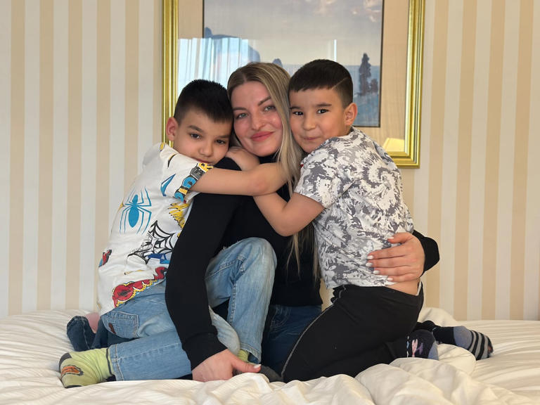 Iryna Lichna and her sons, Samir, left, and Saleem, are staying in a hotel room until the start of April when they will move into an apartment. (Taryn Grant/CBC)