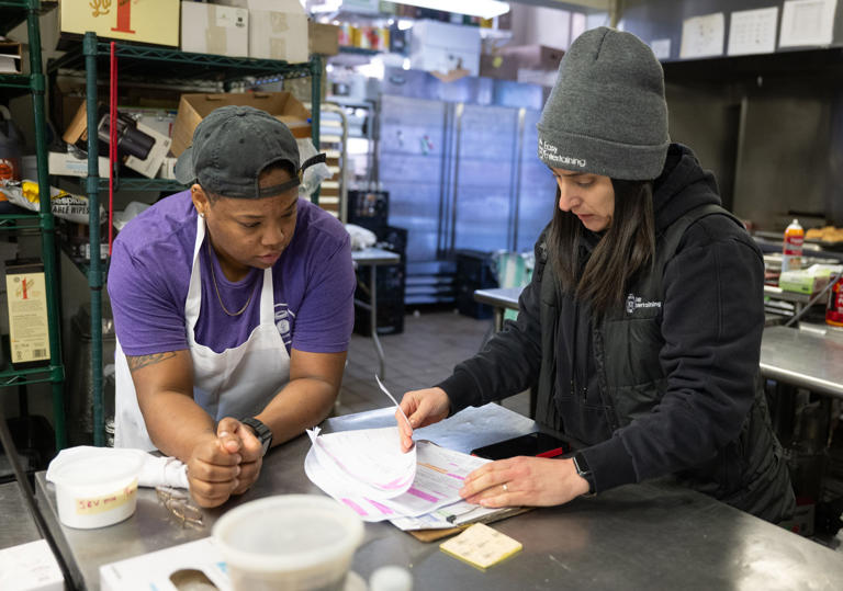 Easy Entertaining executive chef Ashley Vanessa, right, and prep cook Keya Perry, discuss logistics for an upcoming order. The Providence catering company lost over $29,000 when 11 holiday parties were canceled in December because of the Washington Bridge closure.