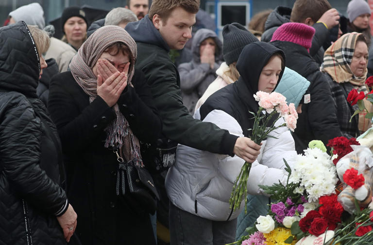 Russian citizens laid flowers in front of the concert venue in Moscow on Sunday.