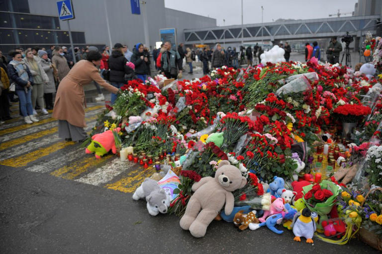 People lay flowers to mourn victims of a terror attack in Moscow, Russia, March 24, 2024. On Friday night, gunmen fired indiscriminately at concert-goers at Crocus City Hall in suburban Moscow.