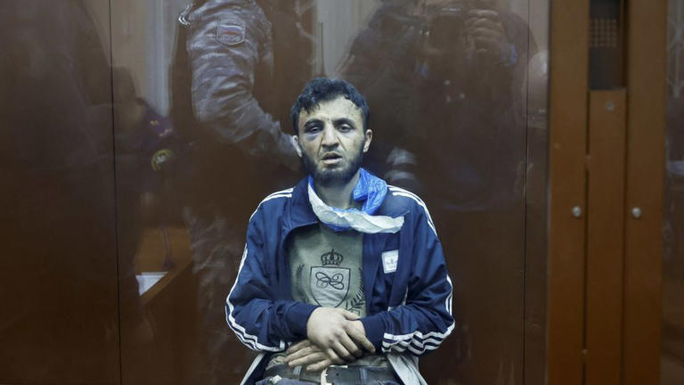 Dalerdzhon Mirzoyev, a suspect in the shooting attack at the Crocus City Hall concert venue, sits behind a glass wall of an enclosure for defendants at the Basmanny district court in Moscow, March 24, 2024. - Shamil Zhumatov/Reuters