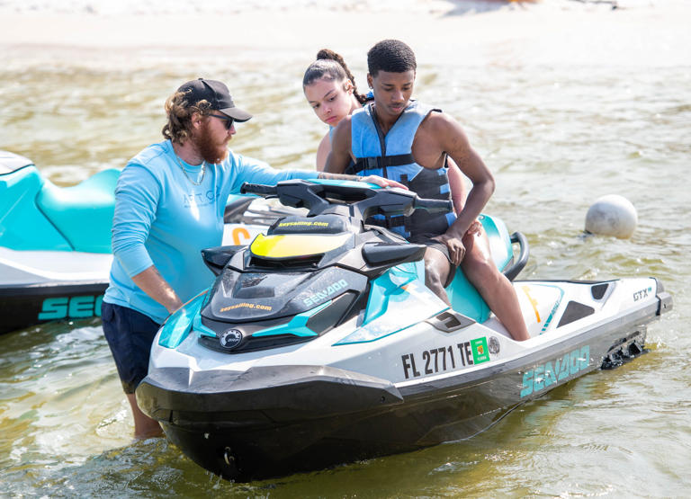From left, Kevin Dorf, of Key Sailing, gives instructions to Tennessee State University freshmen Deja Story and Madison Taylor before they rida a personal watercraft along Santa Rosa Sound in Pensacola Beach on Wednesday, March 8, 2023.