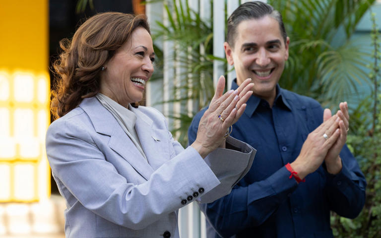 Kamala Harris, left, and Frankie Miranda, Hispanic Federation president, applaud during a visit in San Juan, Puerto Rico - AP