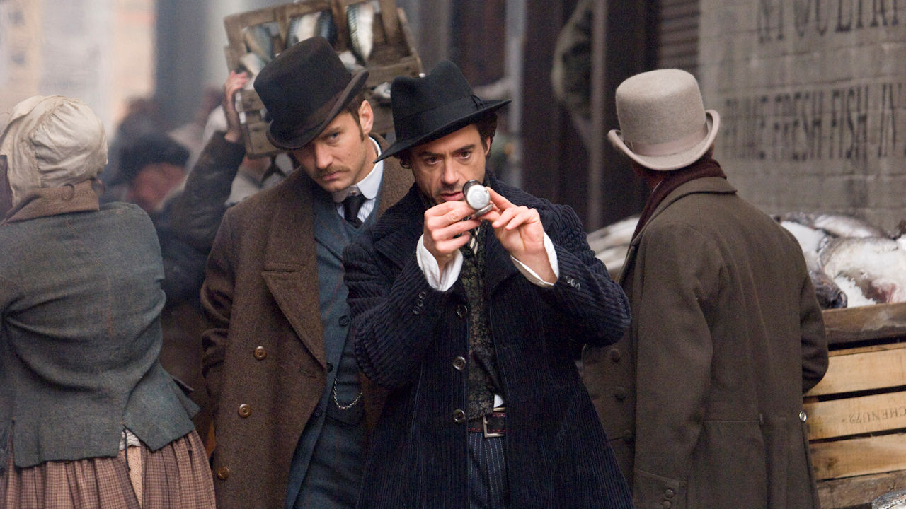 <p>We know this 2009 adaptation is popular, as it stars big names like Robert Downey Jr., Jude Law, and Rachel McAdams. Sadly, the character portrayals and the overall story does not have the brilliance of Doyle’s tales. The sequel, <em>Sherlock Holmes: A Game of Shadows</em>, isn’t any better.</p><p>Sherlock’s dialogue feels appropriate, though Downey’s delivery is often too cheeky. Law is a decent Watson, but he stands up to Sherlock much more than Doyle’s Watson ever did. Our biggest compliment is that Rachel McAdams is a fabulous Irene Adler and delivered the intelligence and strength of Doyle’s Irene.</p>
