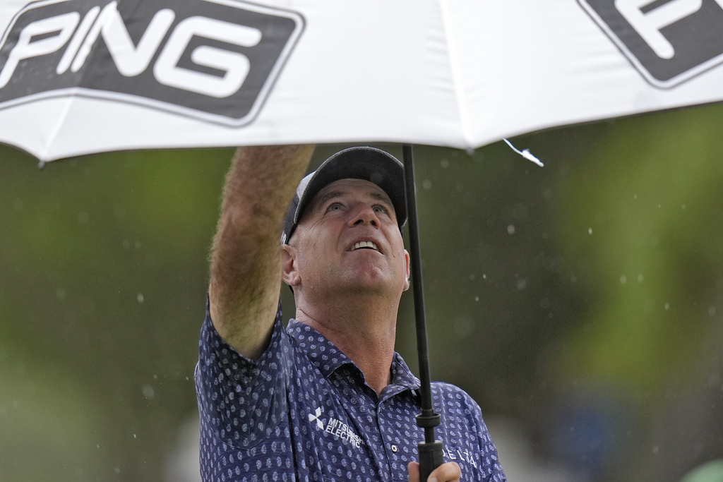 <p>Stewart Cink puts his his umbrella as the rain begins to fall on the eighth hole during the second round of the Valspar Championship golf tournament Friday, March 22, 2024, at Innisbrook in Palm Harbor, Fla. </p>