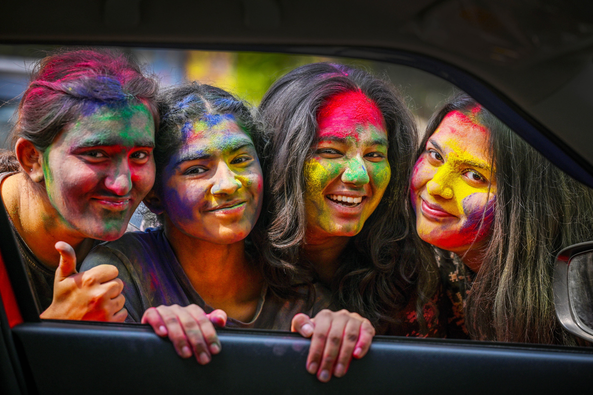 Students play with colors ahead of Holi festival, at outside the Matasundari College in New Delhi, India, on March 21, 2024.