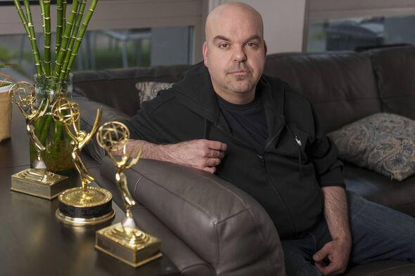 Emmy Award-winning producer Johnathan Walton poses for a photo with his Emmy Awards at his apartment in downtown Los Angeles, Mo