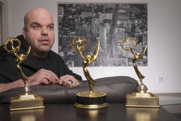 Emmy Award-winning producer Johnathan Walton poses for a photo with his Emmy Awards at his apartment in downtown Los Angeles, Mo