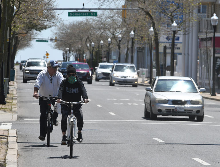 Folks ride their bicycles on Baltimore Avenue Sunday, May 10, 2020 after the town opened the beach and Boardwalk that had been closed since mid-March due to the COVID-19 pandemic.