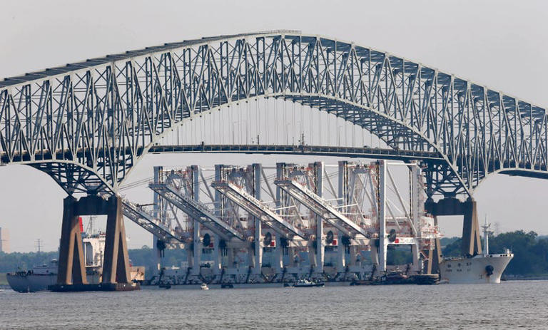A ship carrying four giant shipping cranes for delivery and installation at the Port of Baltimore, passes under the Francis Scott Key Bridge in Baltimore in this file photo from June 20, 2012.
